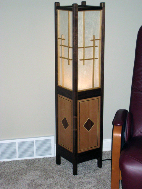 Floor lamp with shoji-screen shade. Materials: walnut, paulownia, pearwood & walnut veneers, shoji paper.  Height 52 in.  Width/Depth 11 in.