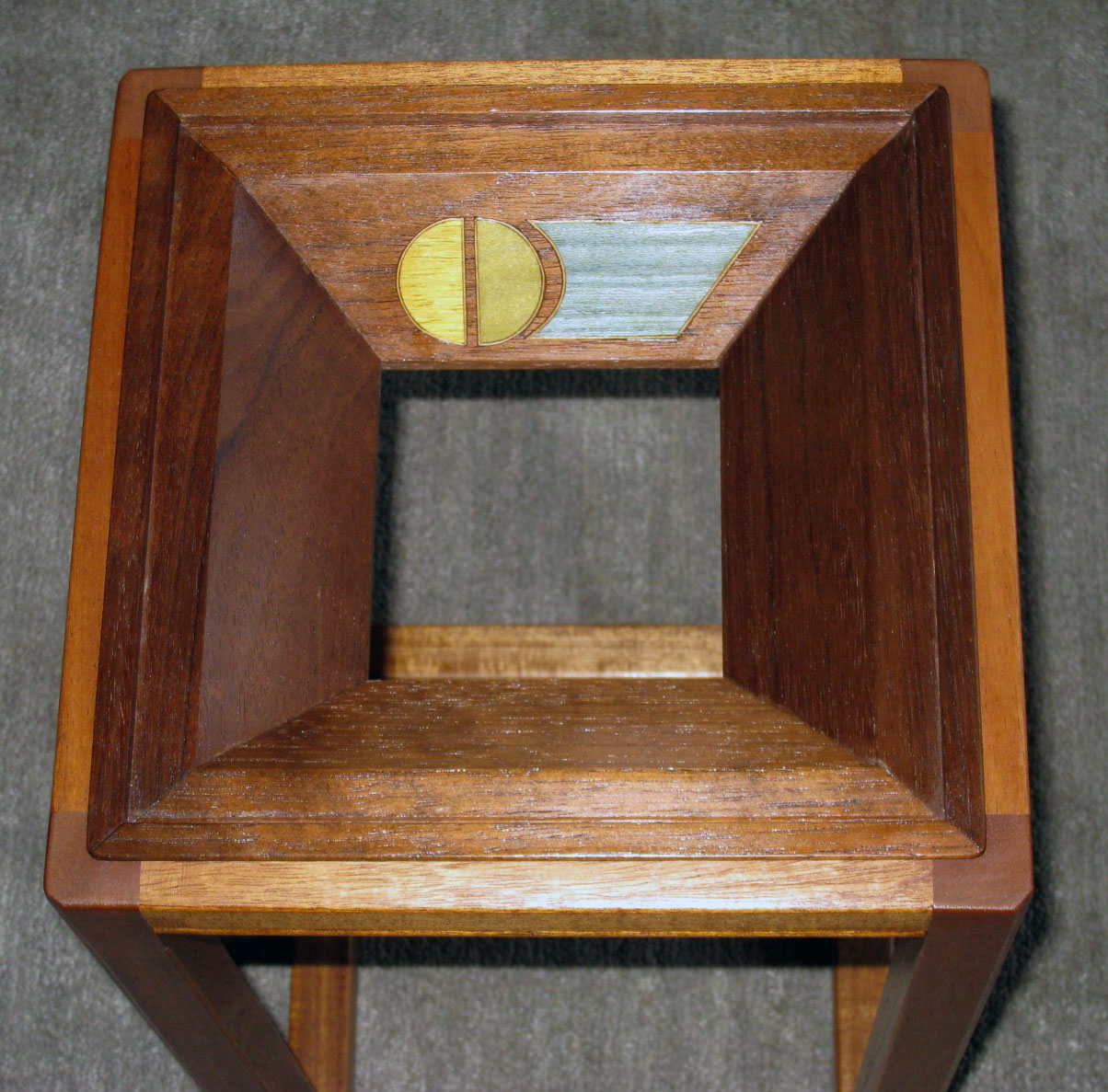 Small Table (glass top removed).  Materials: mahogany and Peruvian walnut.   Colored wood-veneer inlays