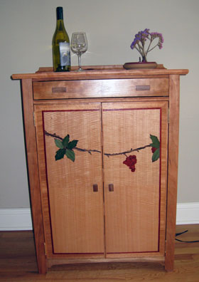 Materials: Pennsylvania Cherry and various veneers. Height 37, Width 28, Depth 18.5 inches.